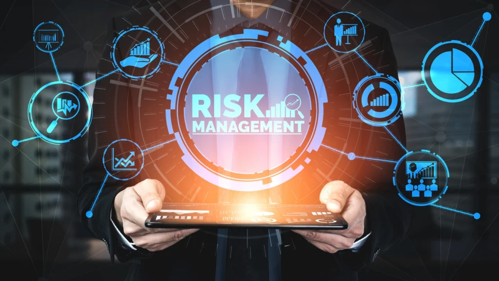 a creative poster with risk management words in it and icons hovering over a tablet